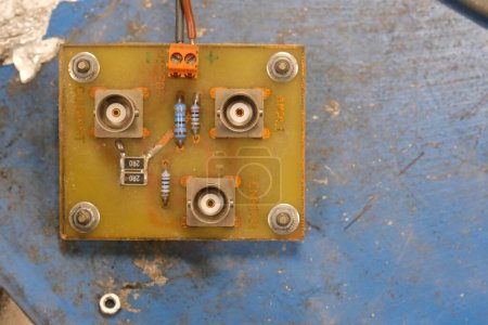 Photo for Male BNC plugs, mounted on an electronic board, on a rusted blue background - Royalty Free Image