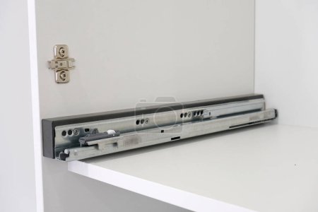 Photo for Drawer guide rail, mounted in a new kitchen cabinet. - Royalty Free Image