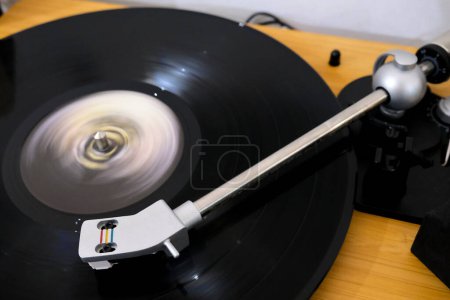 Long exposure pictures of a record player playing a 33 rpm vinyl record. View from above.