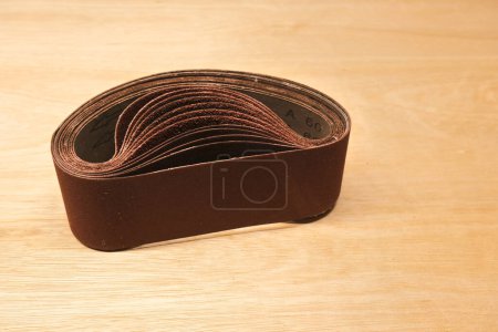 Photo for Sanding paper for belt sander on wood panel. - Royalty Free Image