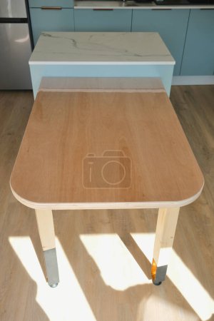 DIY wooden table with plywood top, wood and steel legs.