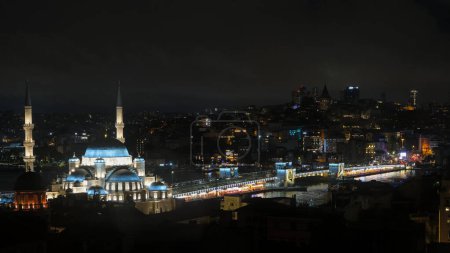 Istanbul, Turkiye - 05 04 2024 : Panoramic night view of the New Mosque and Galata Bridge 