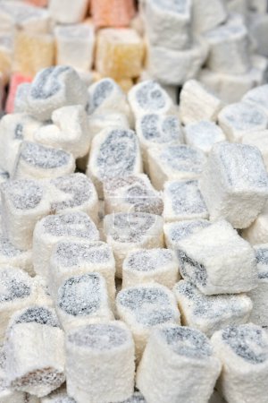 Turkish delight stacked on a bakery shelf