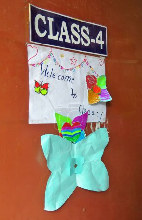 Photo for Orange classroom door decorated with children's drawings, class 4, Kathmandu, Nepal - Royalty Free Image