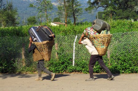 Photo for Porters carrying heavy luggage and suitcases to Tumlingtar airport , Khandbari, Nepal, Asia - Royalty Free Image