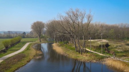 Panoramic view of river and woods, trees reflecting in the water, nature reserve Het Zwin,  Knokke-Heist, North Sea Coast at the border of Belgium and The Netherlands
