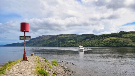 Photo for Loch Ness view point. Pleasure cruise yacht sailing to Fort Augustus marina in scottish highlands landscape. Scotland, United Kingdom, travel Europe - Royalty Free Image