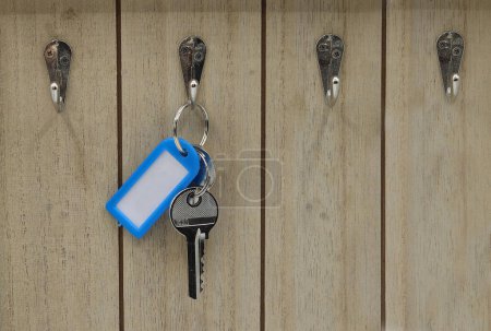 Photo for A key with a sign hanging on a hock - Royalty Free Image
