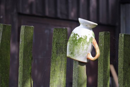 Photo for Detail of a country fence with an old mug - Royalty Free Image