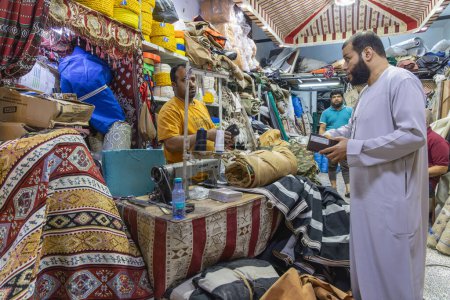 Photo for Middle East, Saudi Arabia, Tabuk Province, Tayma. November 15, 2023. Cloth merchant at the market in Tabuk. - Royalty Free Image