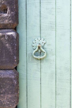 Masham, Ripon, North Yorkshire, Angleterre, Grande-Bretagne, Royaume-Uni. Poignée sur une vieille porte verte en bois.
