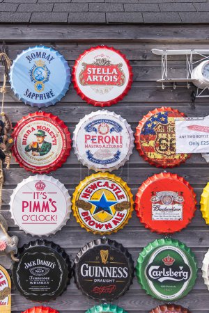 Photo for Amble, Morpeth, Northumberland, England, Great Briton, United Kingdom. May 1, 2022. Decorative signs in the shape of over sized bottle caps. - Royalty Free Image