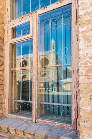 Khiva, Xorazm Region, Uzbekistan, Central Asia. Reflections in a window in Khiva.