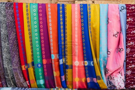 Khiva, Xorazm Region, Uzbekistan, Central Asia. Colorful scarves for sale in Khiva.