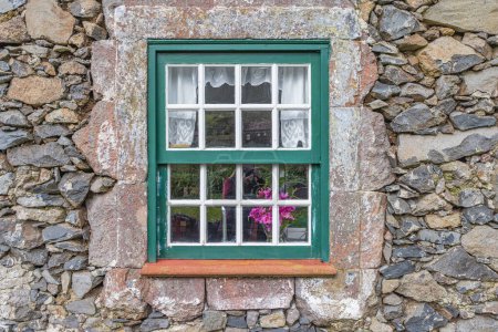 Aldeia da Cuada, Flores, Azores, Portugal. Paned window on a stone building.