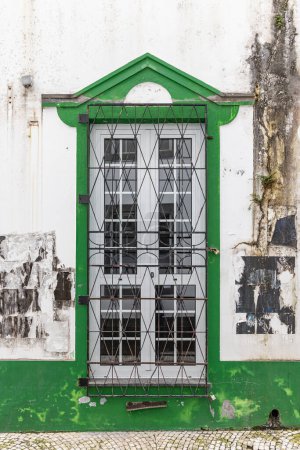 Ponta Delgada, Sao Miguel, Azores, Portugal. Green trimmed window on a white building.