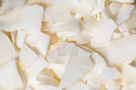 Photo for The texture of coconut flakes as a background. A close shot of a coconut. Macro photo.Coconut flakes. - Royalty Free Image