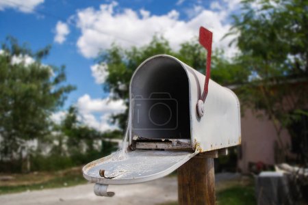 Photo for Open mailbox in the yard of a house Cobweb inside mailbox - Royalty Free Image