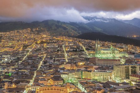 Photo for Panoramic view at golden hour of the colonial old town of Quito wich lies at the foot of the Basilique of the National Vow and with the Belmonte Plaza de Toros in the foreground - Royalty Free Image