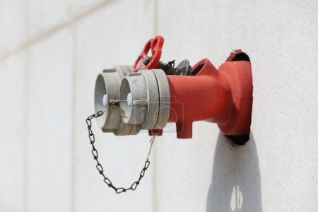 red fire hydrant mounted on the wall