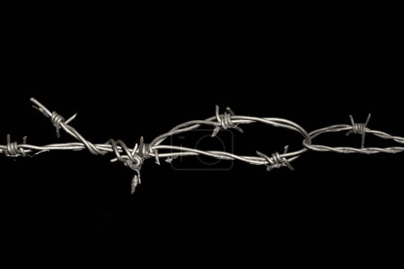 Photo for Barbed wire fence close up with black background - Royalty Free Image