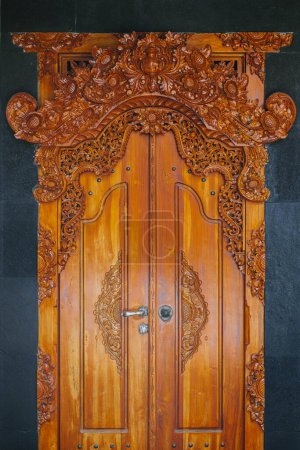 Photo for Wooden doors made of teak wood with Balinese designs and ornaments - Royalty Free Image