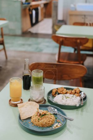 Photo for Portrait or vertical and selective focus shot of several kinds of foods and drinks on the sage green pastel table with blurry background - Royalty Free Image