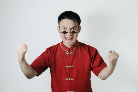Photo for Happy face of Asian man wearing traditional costume while looking at the camera on white background. Chinese New Year concept. Gong Xi Fa Cai. - Royalty Free Image