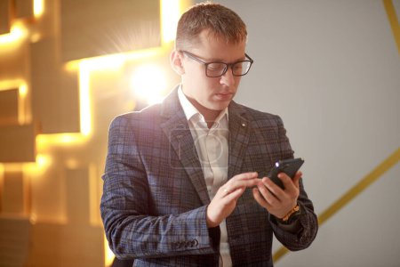 Businessman typing a text message on a smartphone, online work, office - manager.