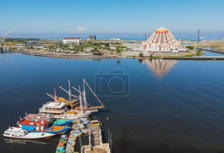 Photo for Aerial view of Masjid 99 Kubah (99 Domes Mosque) and its surrounding, a beautiful Mosque with unique architecture, located in famous destination, Losari Beach, Makassar, South Sulawesi, Indonesia. - Royalty Free Image