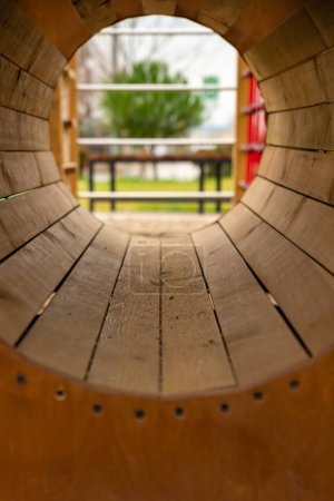 Photo for Tunnel in modern playground from wood material ,childrens playground in the city ,modern playground made of wood , . High quality photo - Royalty Free Image