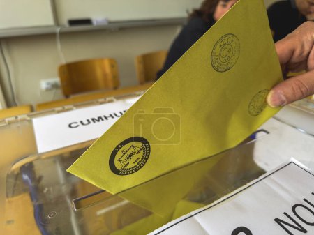 Photo for Bursa , Turkey - May 28, 2023: Close-up shot of a man's hand casting her vote into a ballot box during the elections in Turkey. High quality photo - Royalty Free Image