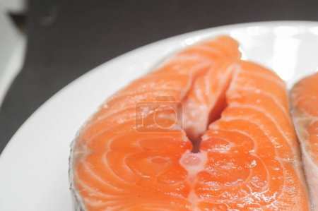 Photo for A piece of Atlantic salmon (Salmo salar) lies on a plate - Royalty Free Image