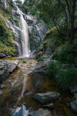 Waterfall caresses the granite rock before falling into a pool and forming a stream in Toxa Pontevedra Galicia