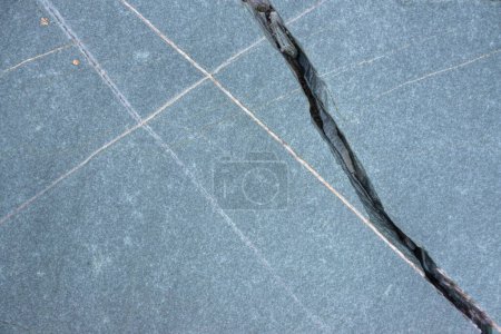 Cracks and white lines of intrusion in marine slate on the coast of Ribadeo in Lugo Galicia