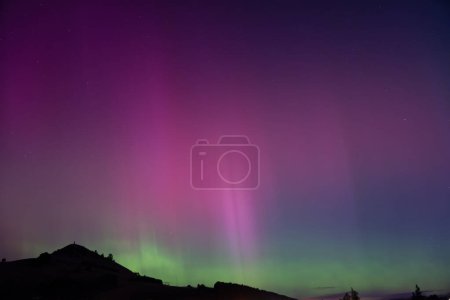Aurora Australis over Puketapu mountain in Palmerston, Otago. Palmerston is located in the South Island of New Zealand, where the southern lights can sometimes be seen. 