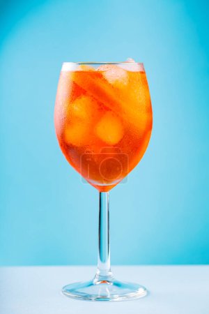 Téléchargez les photos : Cocktail Aperol Spritz en verre sur fond bleu. Apéritif italien classique Aperol Spritz cocktail à l'orange et glaçons. Gros plan - en image libre de droit