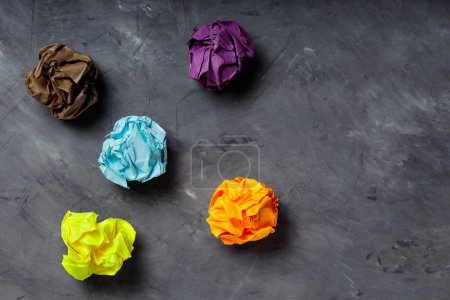 Photo for Crumpled Colorful Paper Balls on Gray Concrete, Concept of Uselessness and Worthlessness - Royalty Free Image