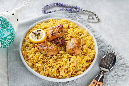 Plate of Traditional Chicken Biryani with Cutlery on Gray Background, Close-up