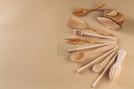 Wooden Kitchen Utensils Collection on Beige Background, Top View, Copy Space