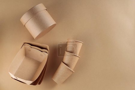 Eco-Friendly Food Delivery Containers and Disposable Cups Made of Cardboard on Beige Background, Copy Space