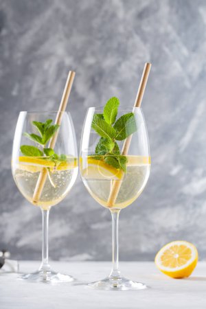 Refreshing Hugo Spritz Cocktail with Elderflower Cordial and Sparkling Wine in Glasses on Concrete