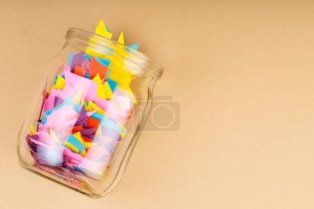 Glass Jar Filled with Colorful Paper Scraps, Reducing Paper Waste Concept, Copy Space