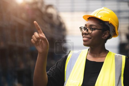 Photo for Black African smart women engineer worker finger point counting stock in factory industry warehouse proud smiling - Royalty Free Image
