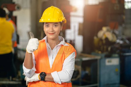 Photo for Portrait teen working woman in heavy industry lathe machine steel tool factory happy smile thumbs up - Royalty Free Image