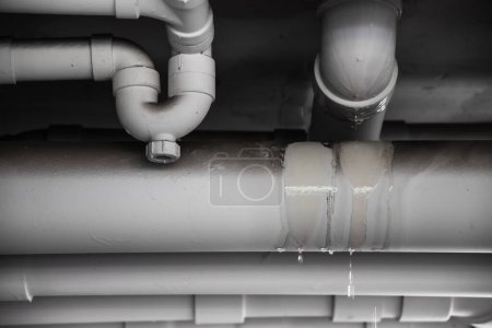 Photo for PVC Water leak pipe, Building Drainage pipes crack seep problem need to fix - Royalty Free Image