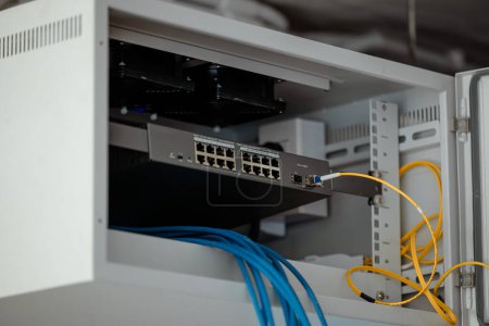 Photo for Single rack LAN network switching in cabinet install internet sharing link site with Fiber optic gigabit. - Royalty Free Image