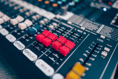 Sound mixer or concert sound engineer, closeup studio motorized volume level control sliders stero split channel device
