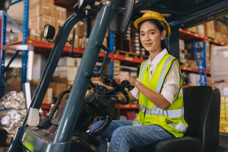 Forklift driver young staff lady worker in warehouse logistics loading cargo products storage industry
