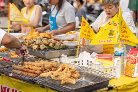 Photo for Vegetarian Festival (J Festival) In Thailand at Yaowarat Bangkok China town, Street food kiosk decoration yellow flag sign for no meat ingredient food. 14 October 2023. Bangkok, THAILAND. - Royalty Free Image